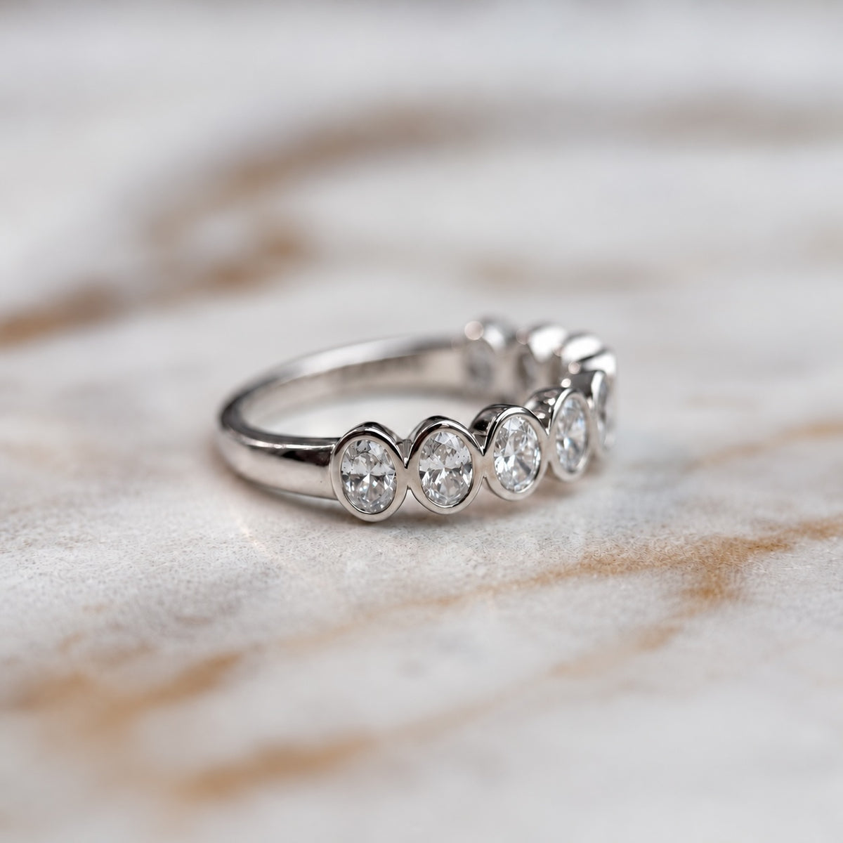 Oval bezel set half band - 0.80ct+